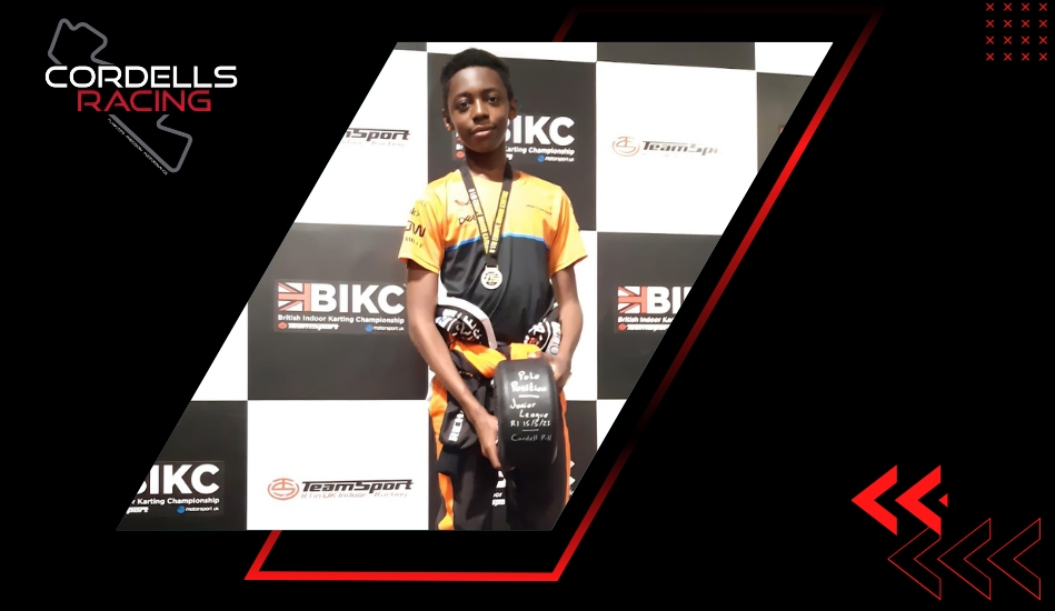 Young Cordell's Racing competitor holding a trophy and wearing a medal at a karting championship.